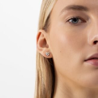 Minimalistic heart-shaped silver stud earrings.